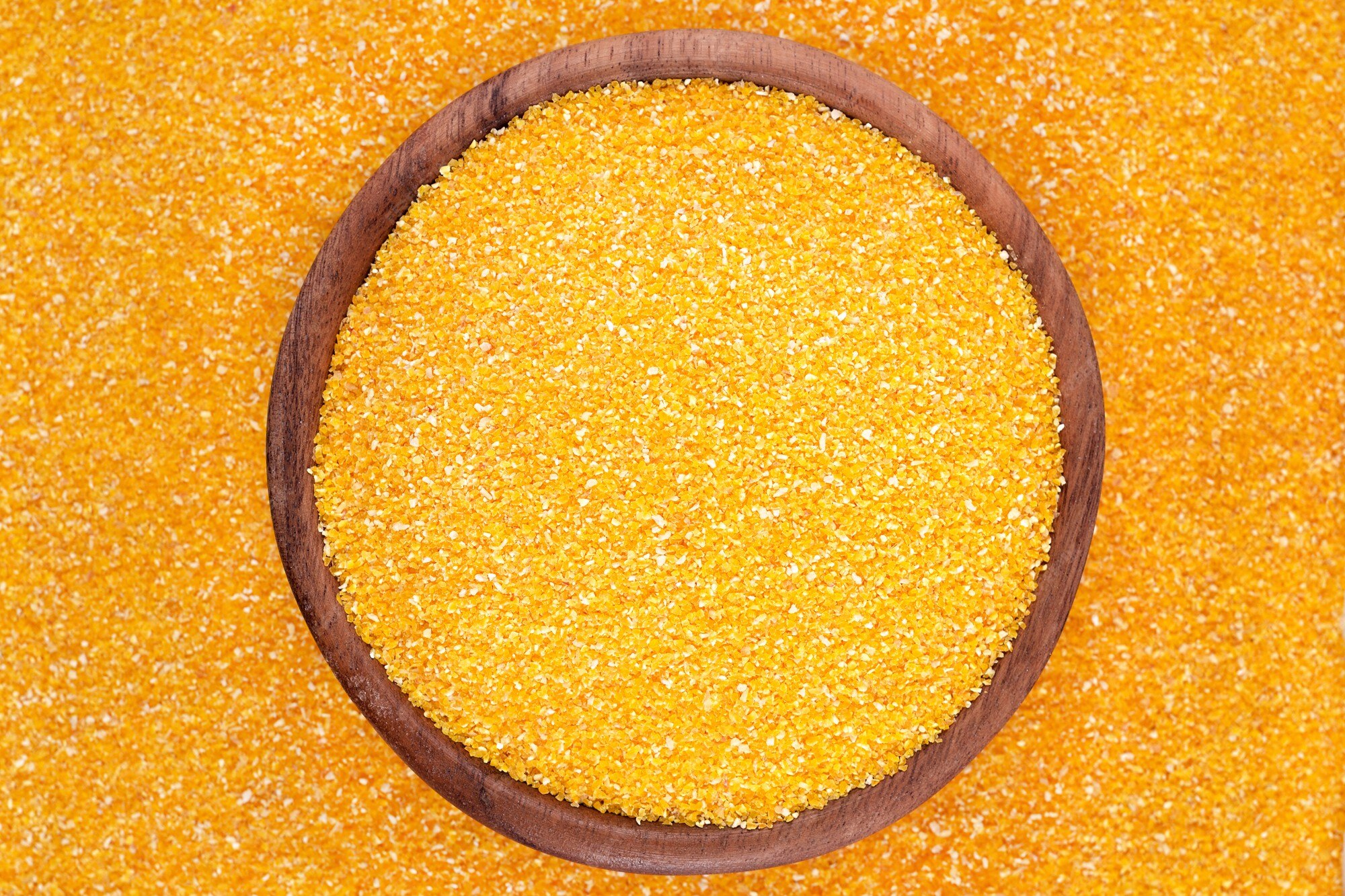Corn grits in wooden bowl